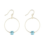 A pair of gold filled hoop earrings with blue aquamarine crystal cubes attached to the hoops.
