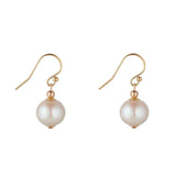 A pair of gold filled earrings featuring a single fresh water pearl drop.