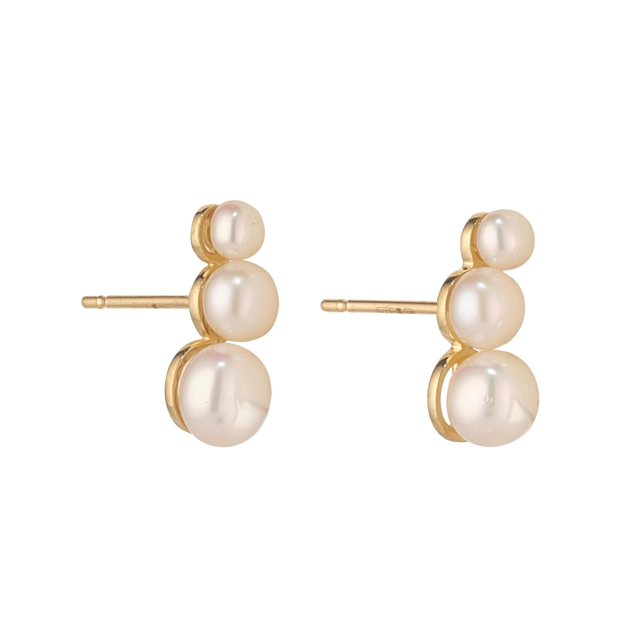 Pair of pearl earrings with gold posts on a white background