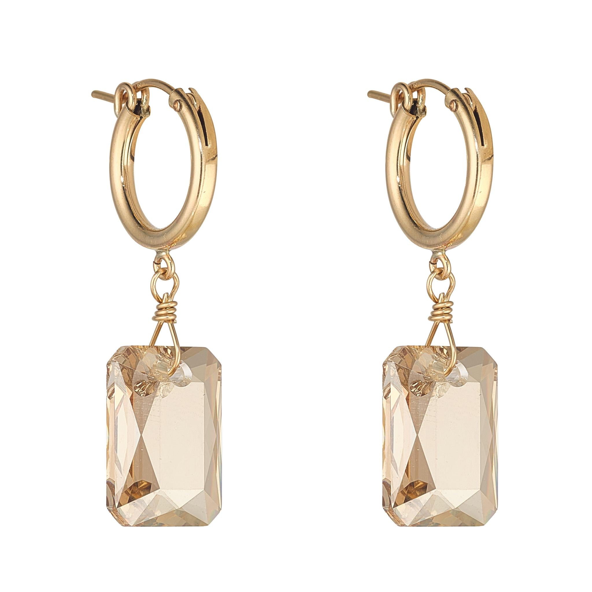 A pair of gold-filled clip hoop earrings with emerald cut golden shadow crystals.