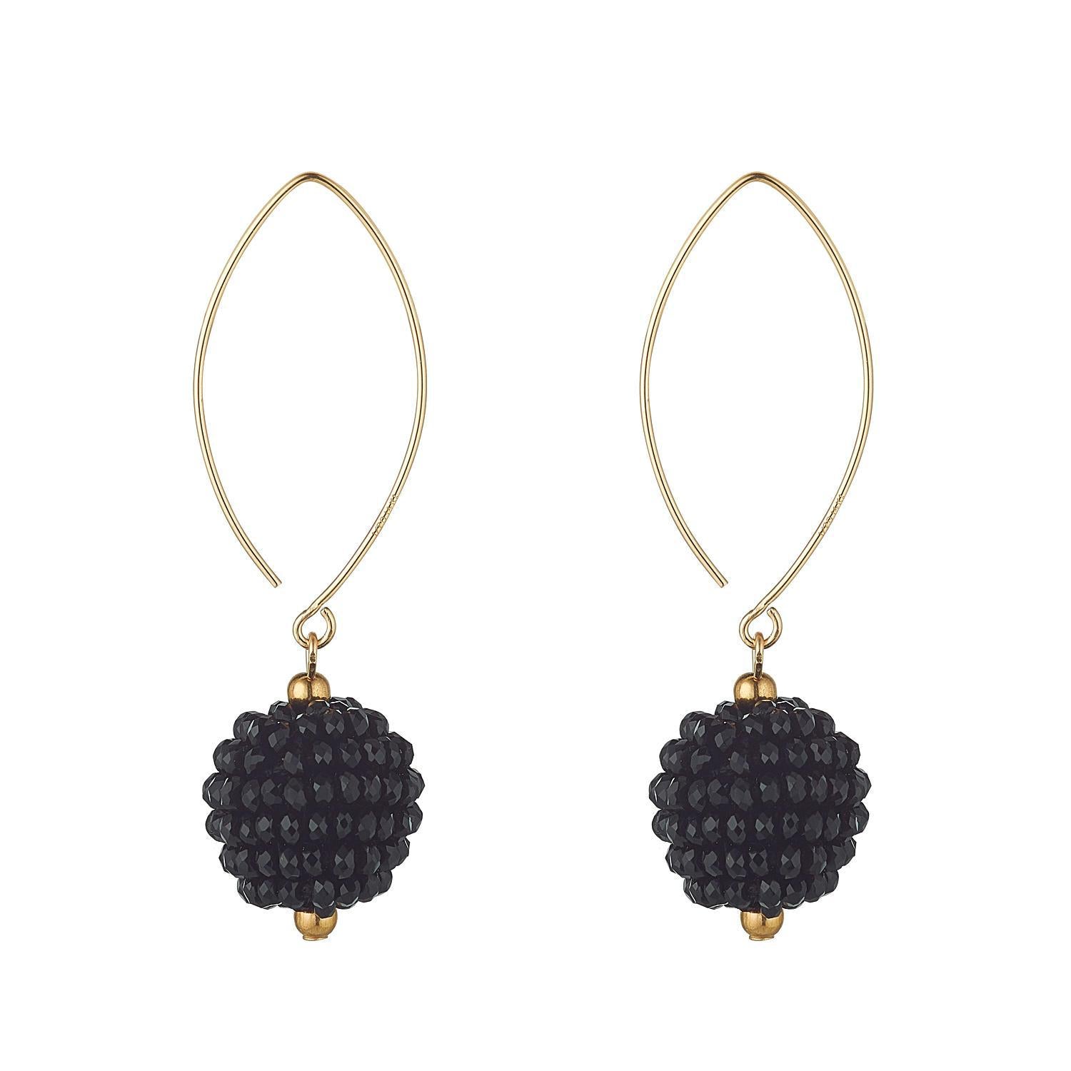 A pair of gold-filled dangling earrings featuring a cluster of small black crystals on an oval open design.