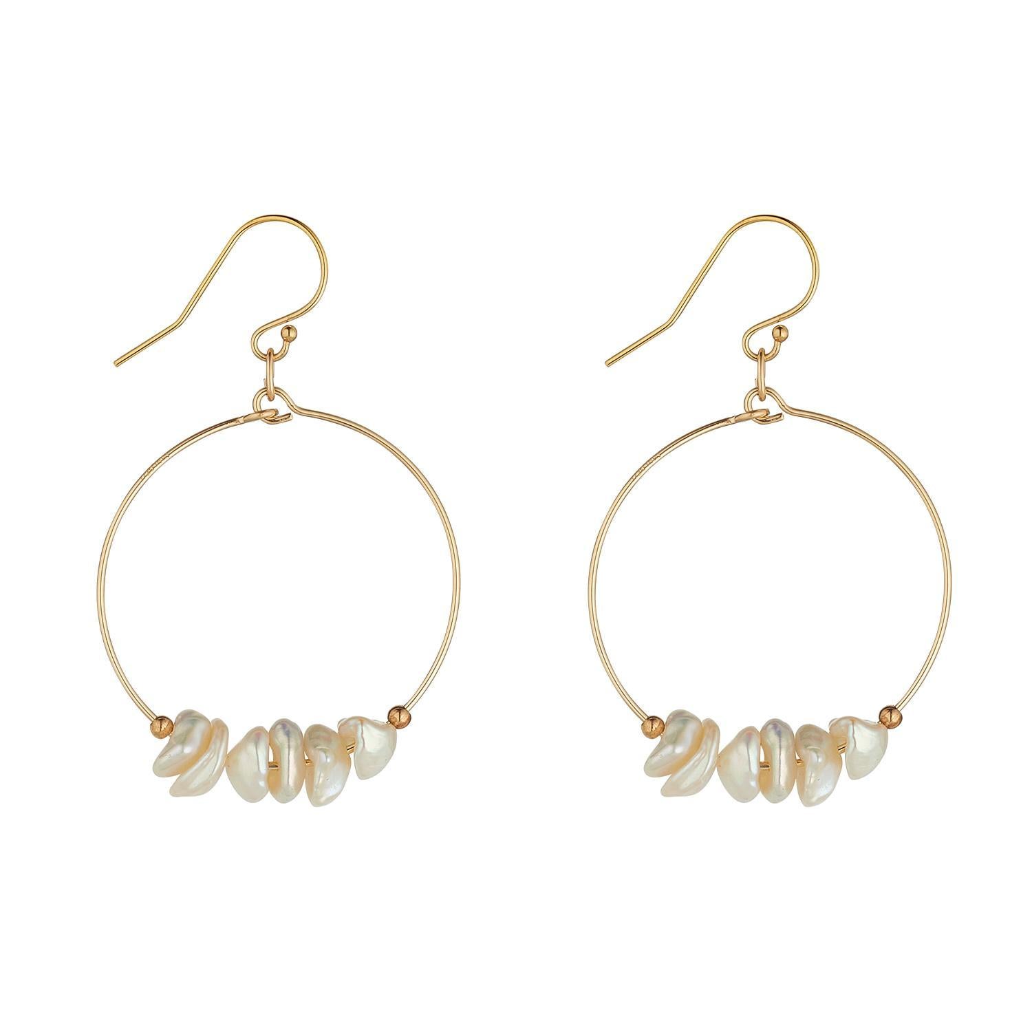 A pair of gold filled small hoop earrings featuring multiple small saucer pearls.