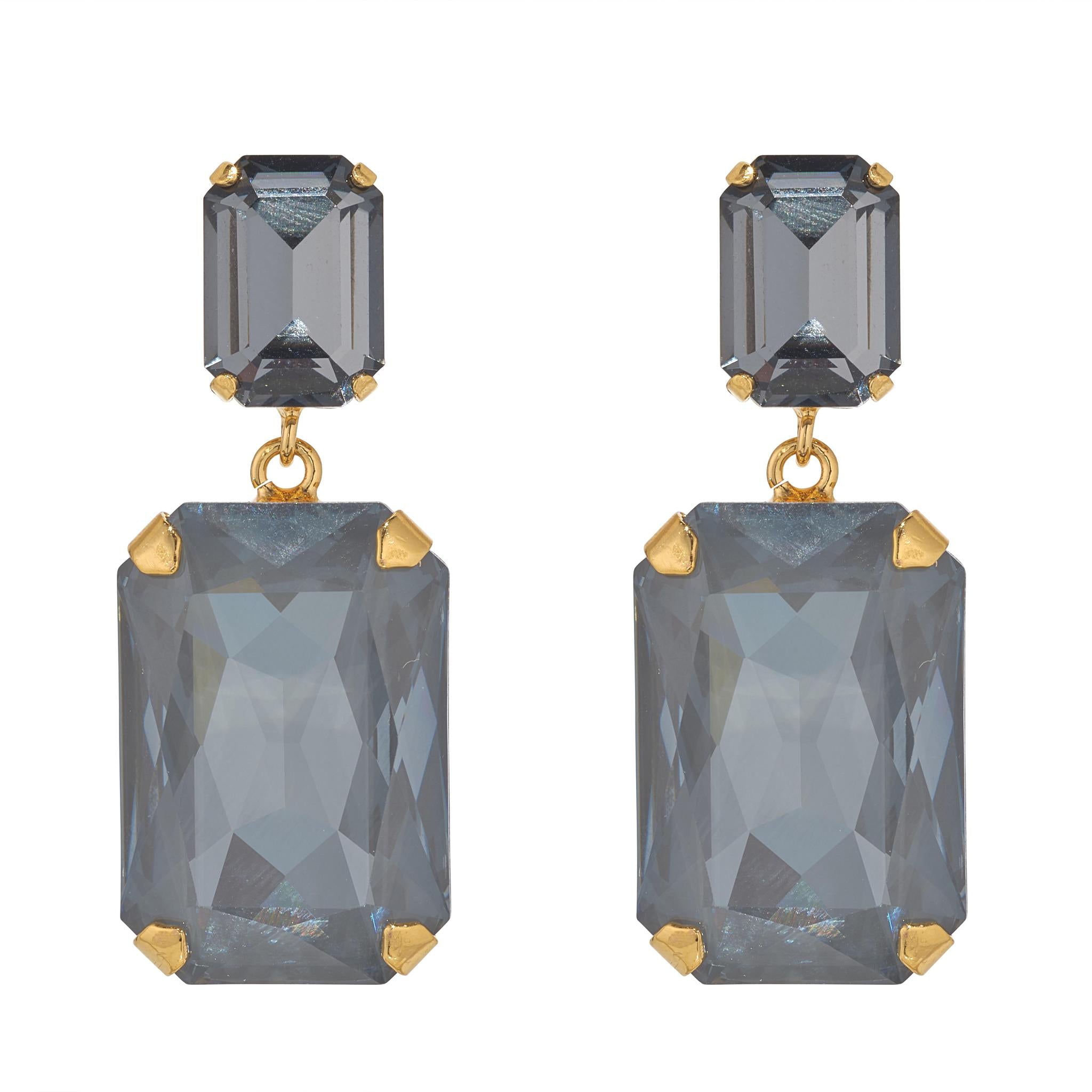 Pair of earrings with large rectangular gemstones and gold accents on a white background