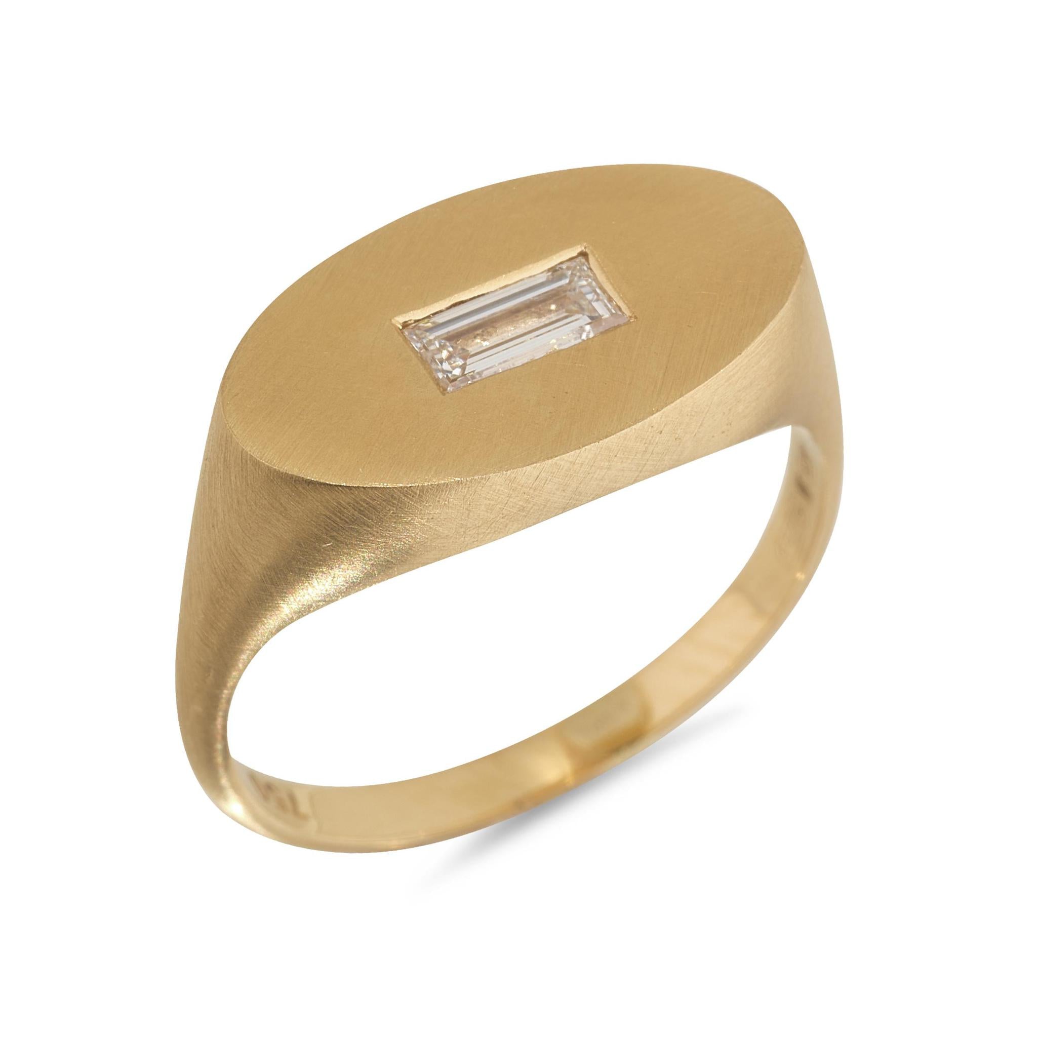 An 18kt yellow gold signet ring with a baguette diamond set on the top, designed and hallmarked in Dublin.