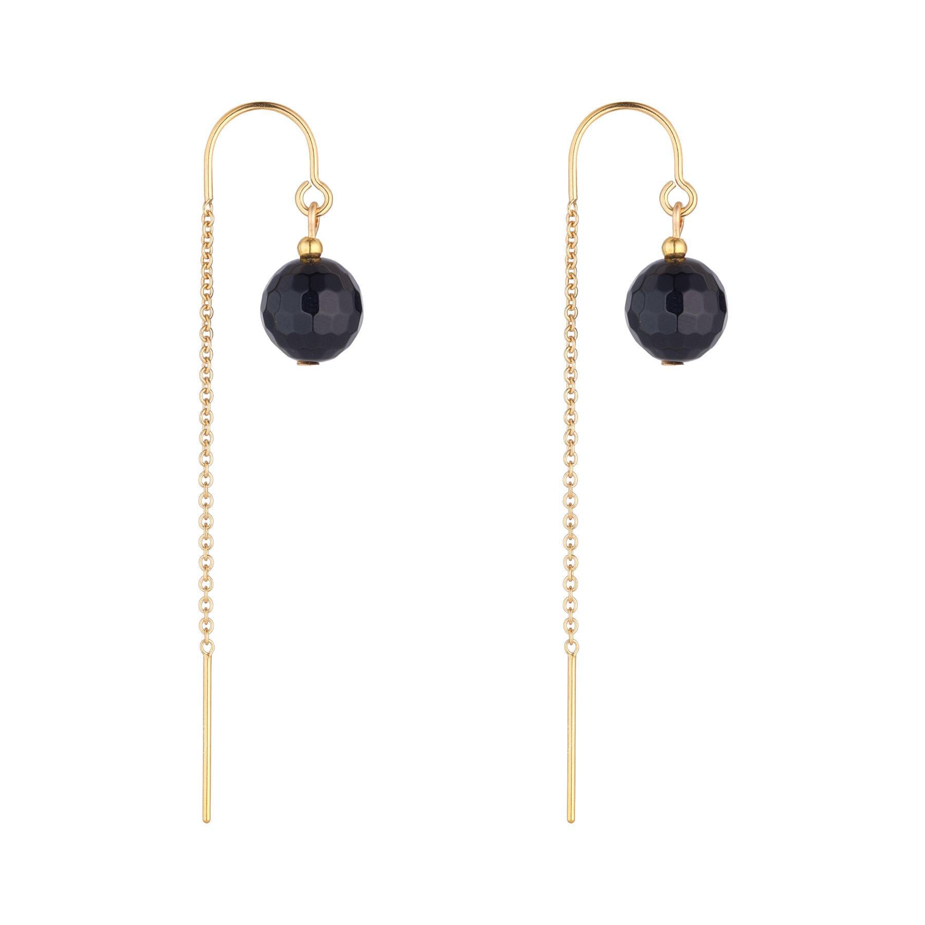 A pair of gold-filled earrings with black agate spheres as the focal points, featuring chain threaders.