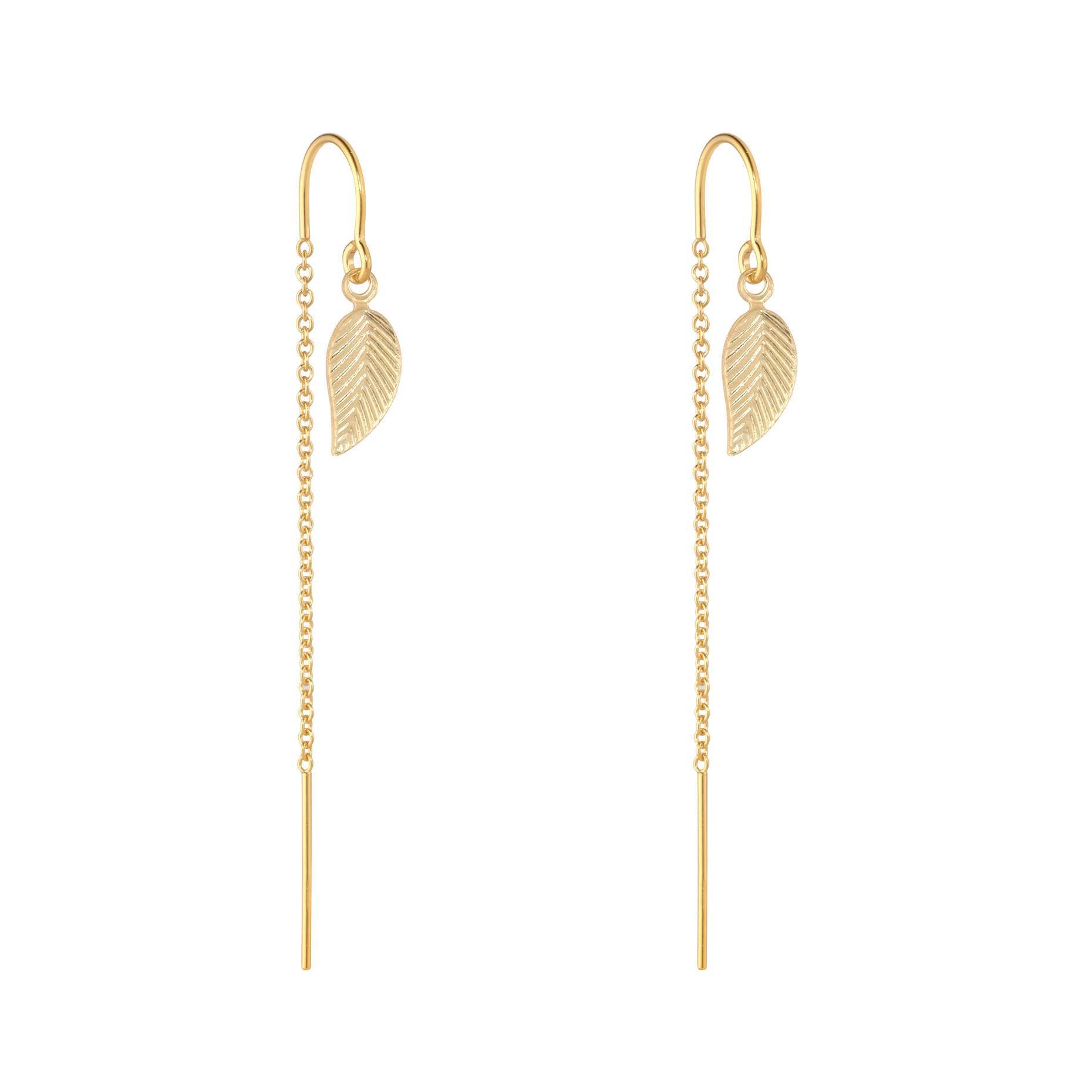 A pair of gold-filled leaf-shaped half threader earrings on a white background.