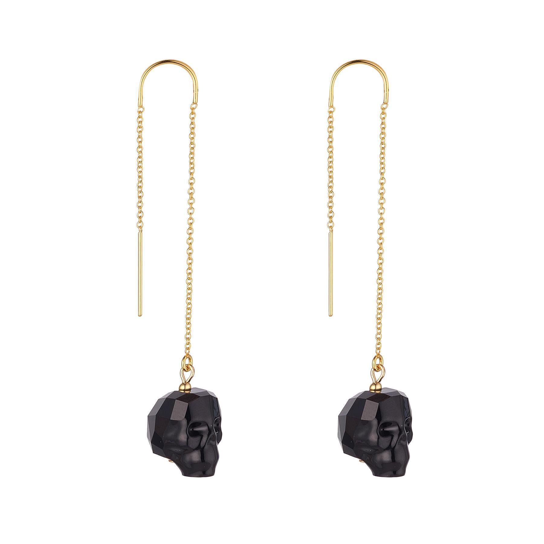 A pair of gold-filled threader earrings with black crystal skulls.
