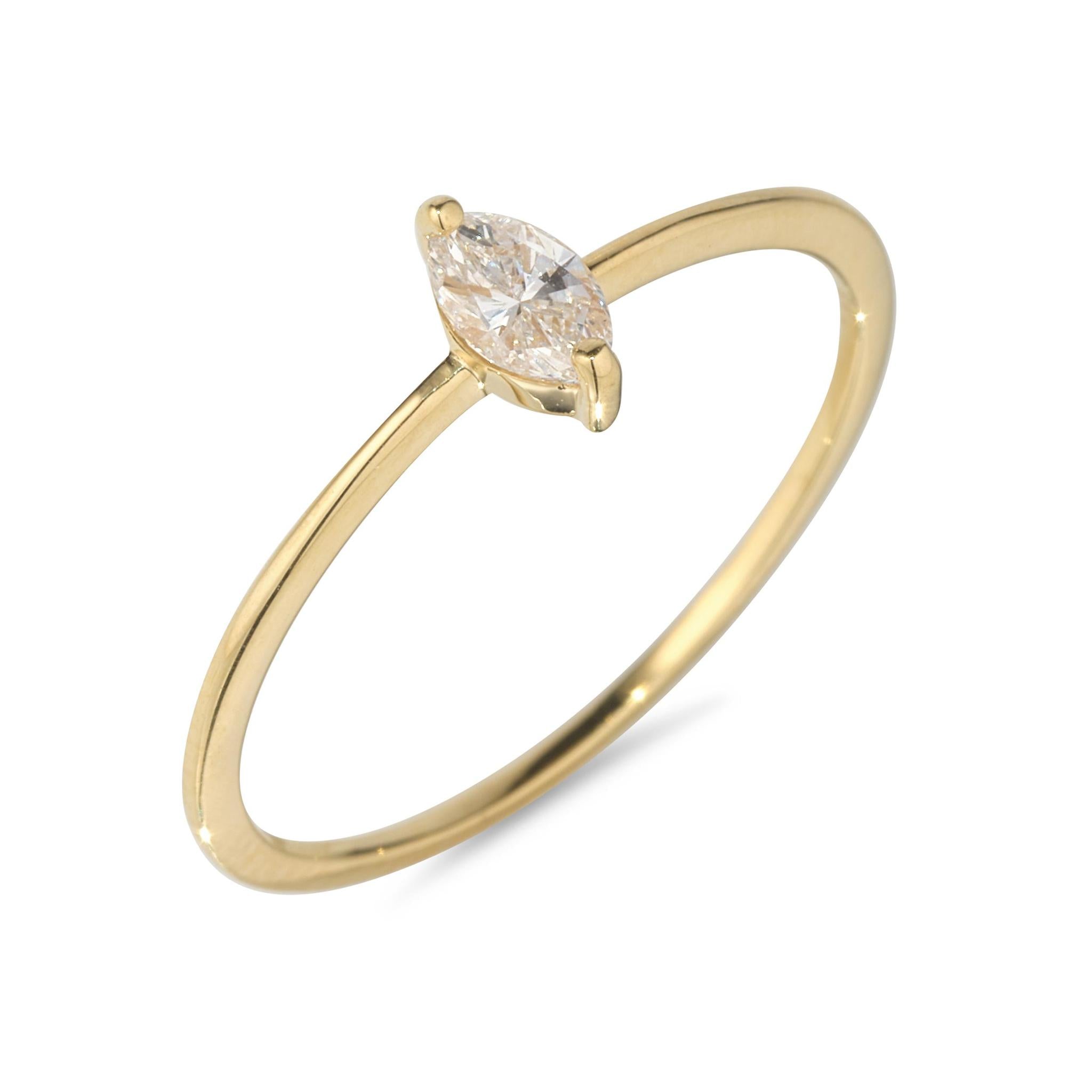 A 18kt gold ring featuring a single marquise diamond set in a sleek, gold band.