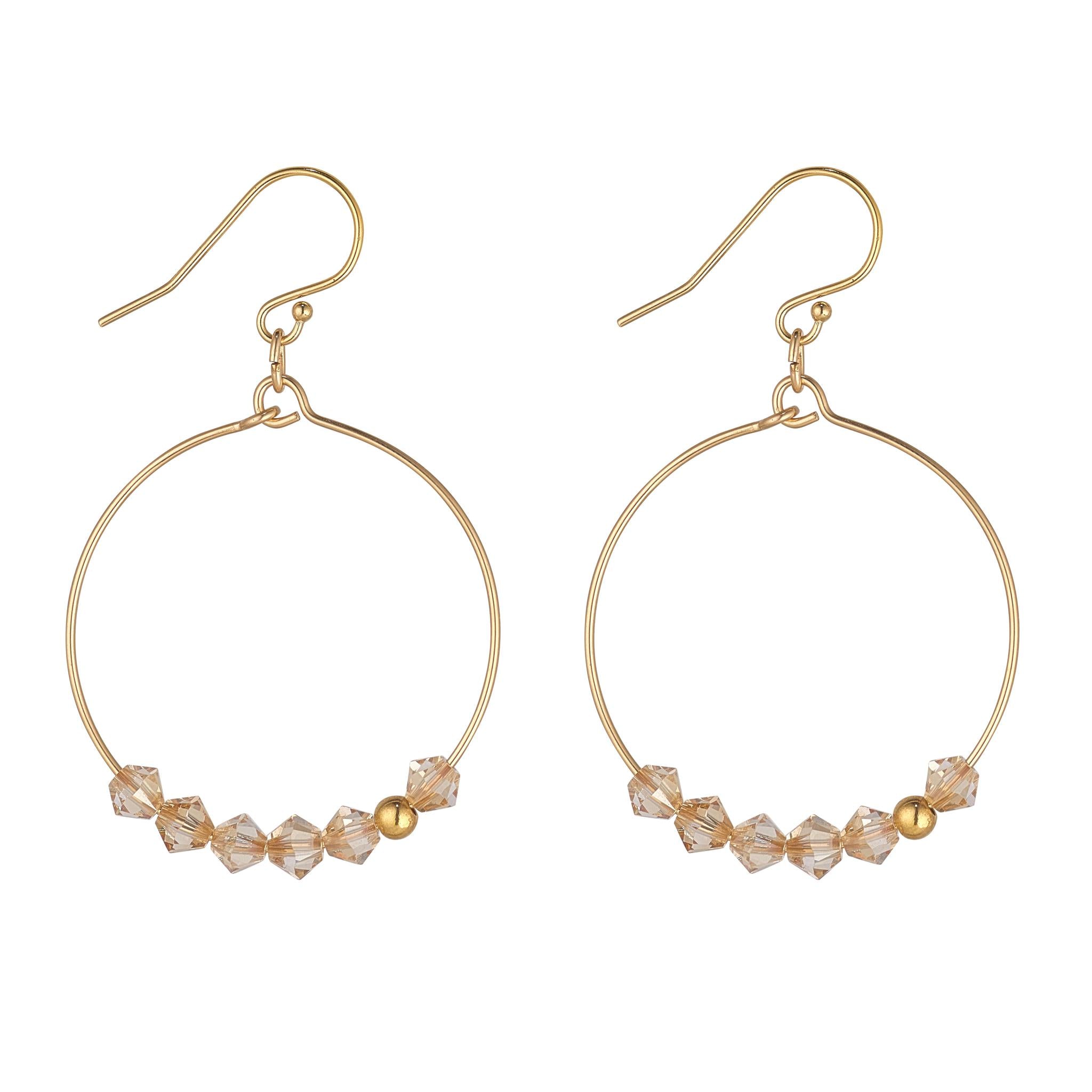 A pair of gold-filled hoop earrings with a row of golden shadow crystals attached to them.