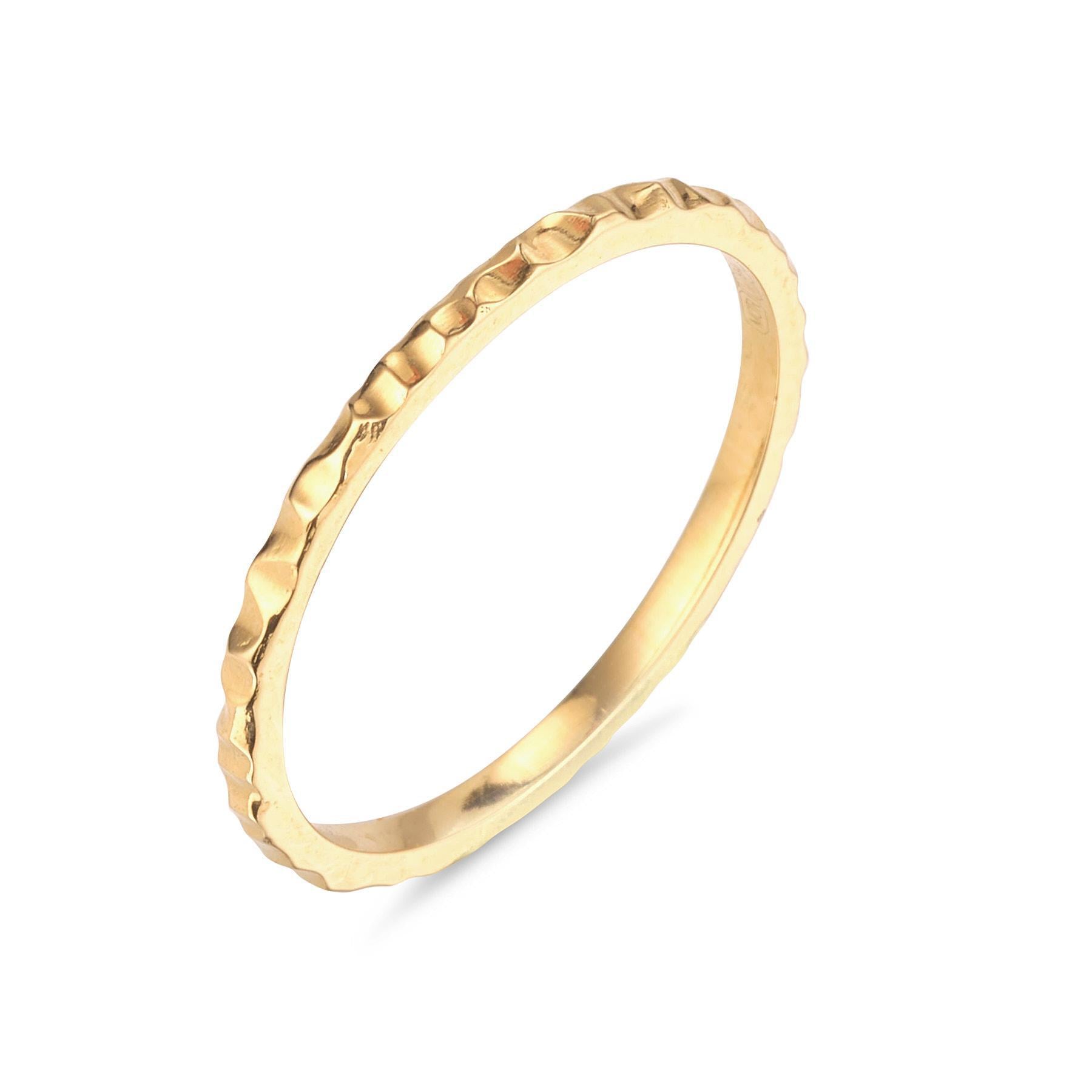 A simple textured 18kt gold band ring