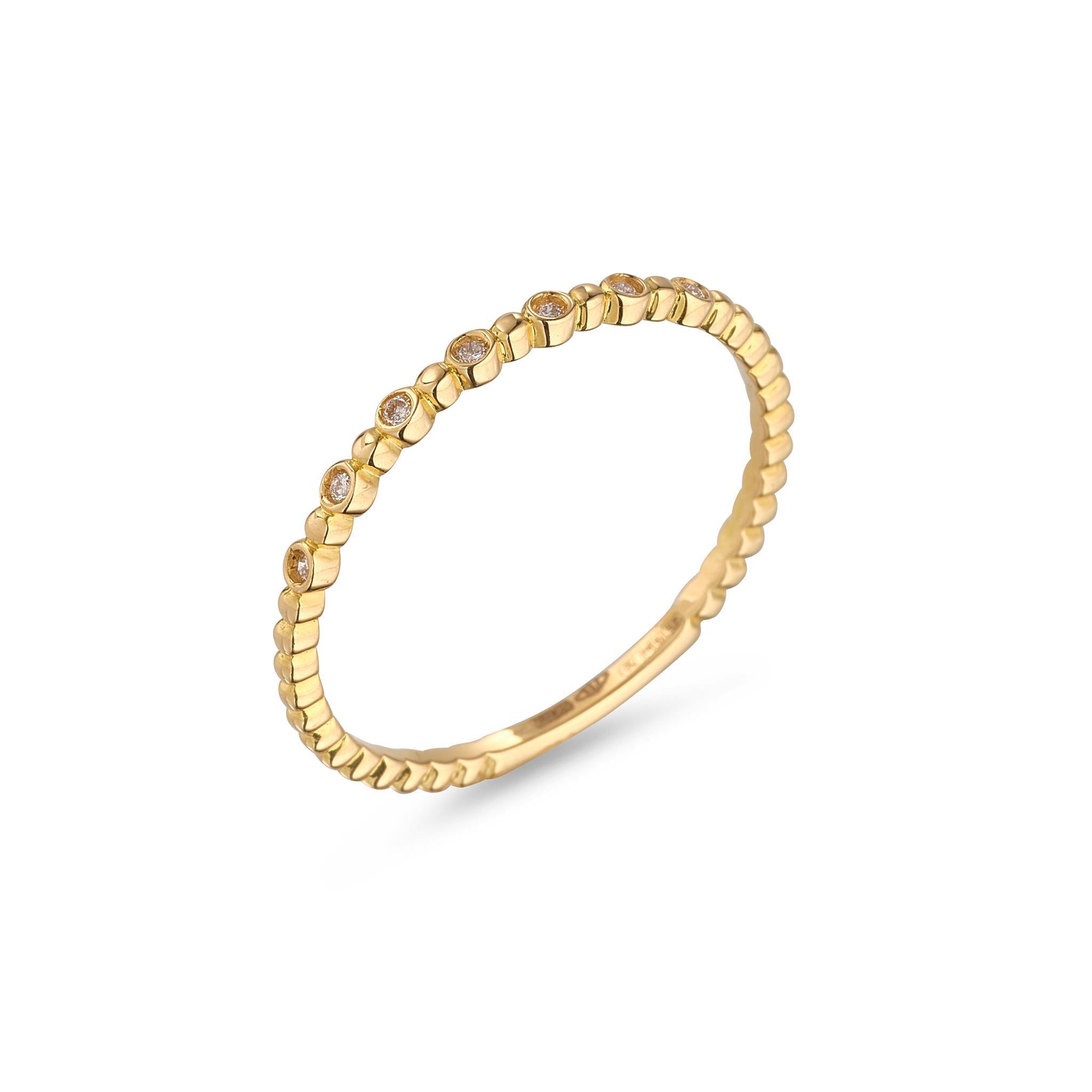 A 18kt gold beaded ring with small white diamonds set into the band