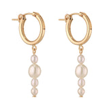Gold filled hoop earrings with baroque pearl drops on a white background