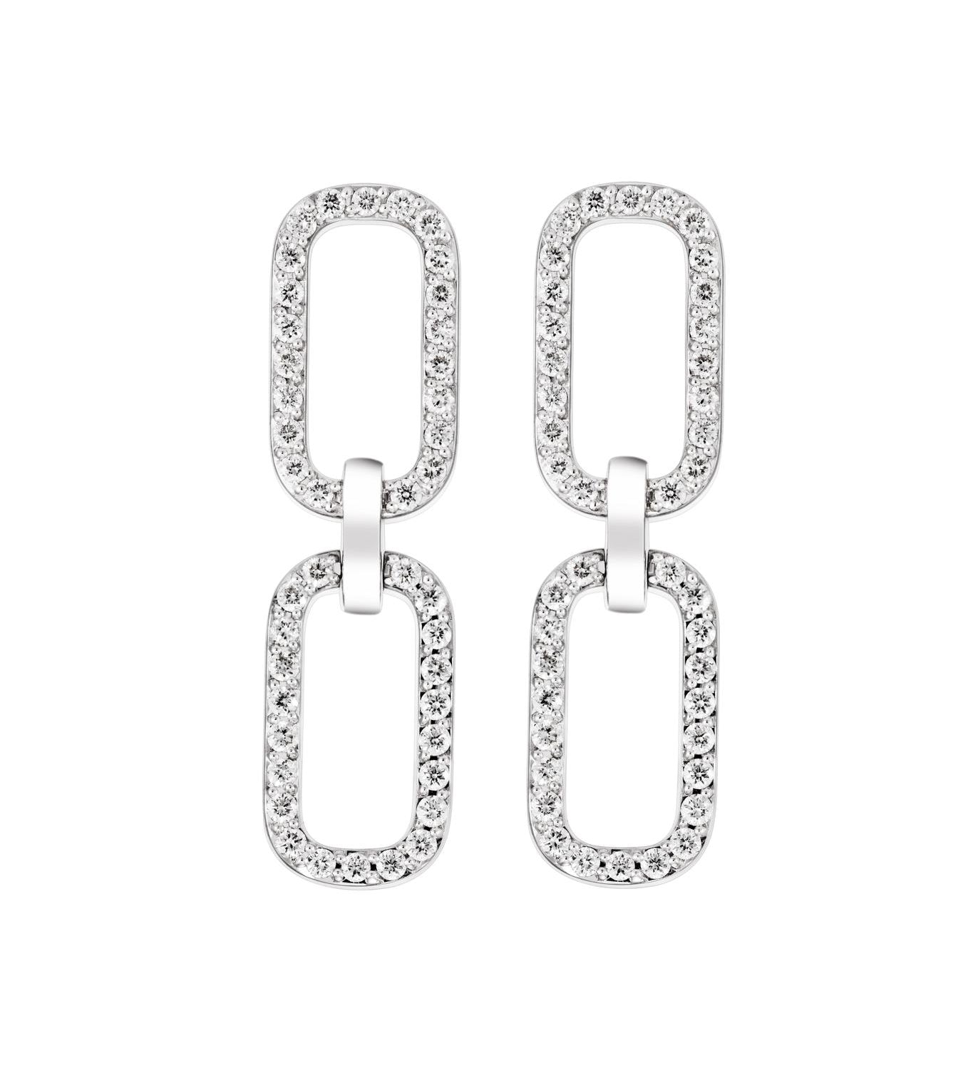 Pair of white gold drop earrings with clear diamond gemstones on a white background