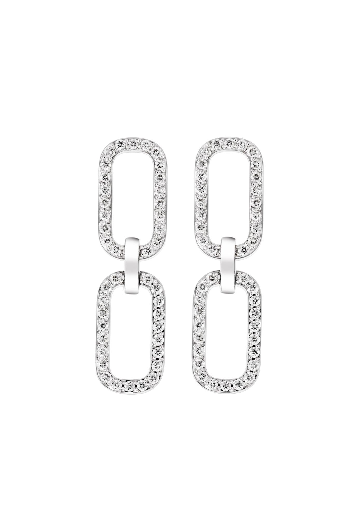Pair of white gold drop earrings with clear diamond gemstones on a white background