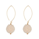 Pair of cream crystal drop earrings with gold hooks on a white background