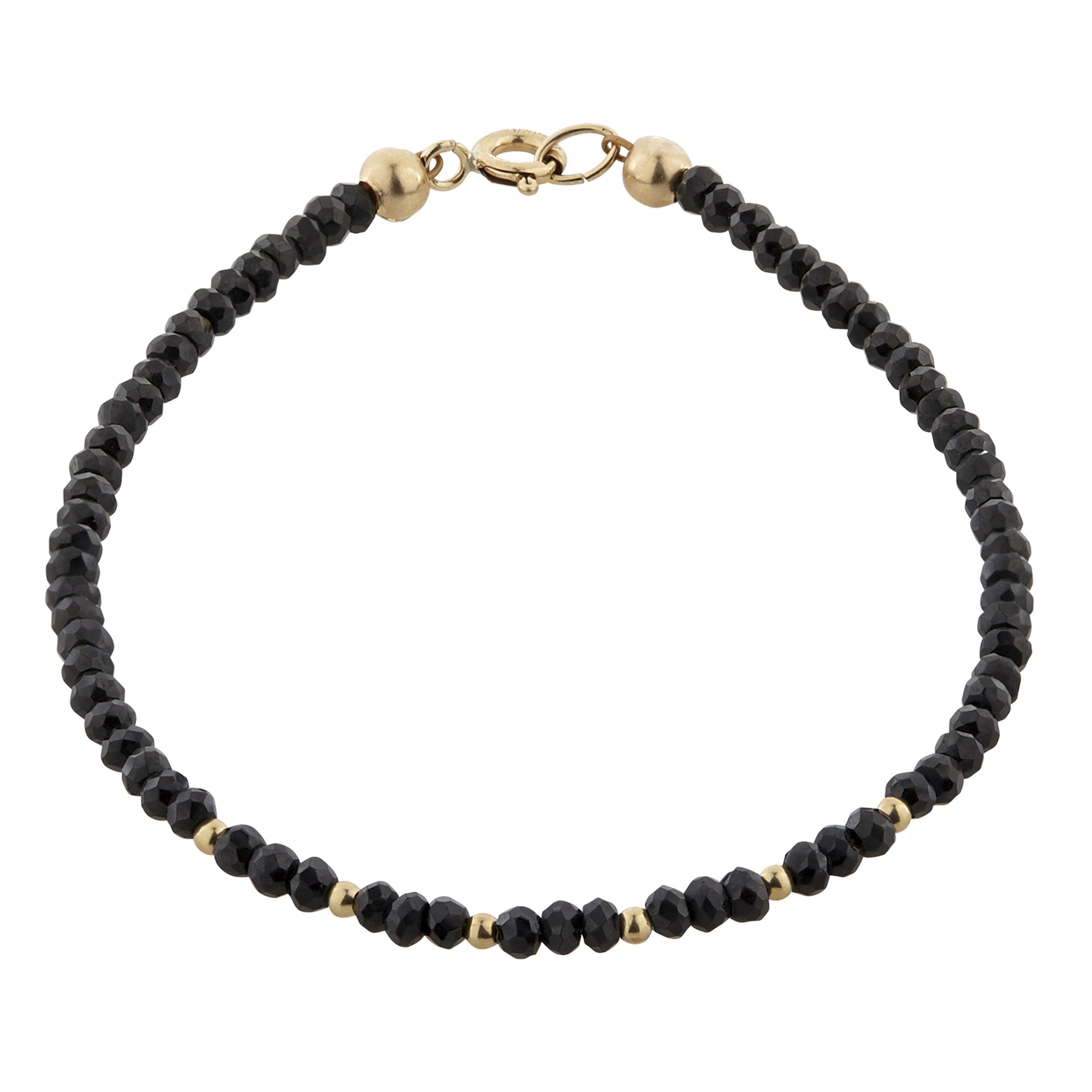 A beaded bracelet with black crystals and gold filled beads, featuring a gold clasp.