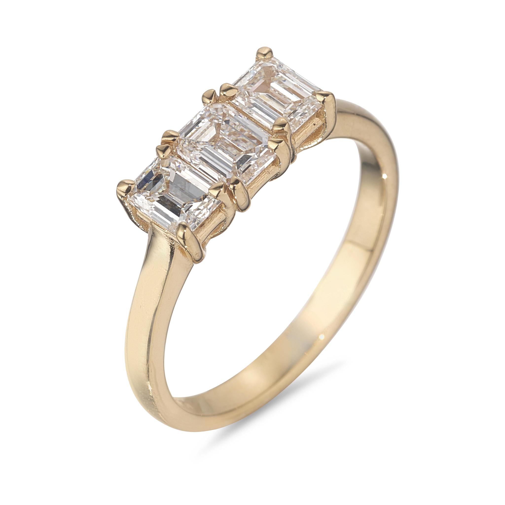 An 18kt yellow gold ring with three diamond steps design on a band.