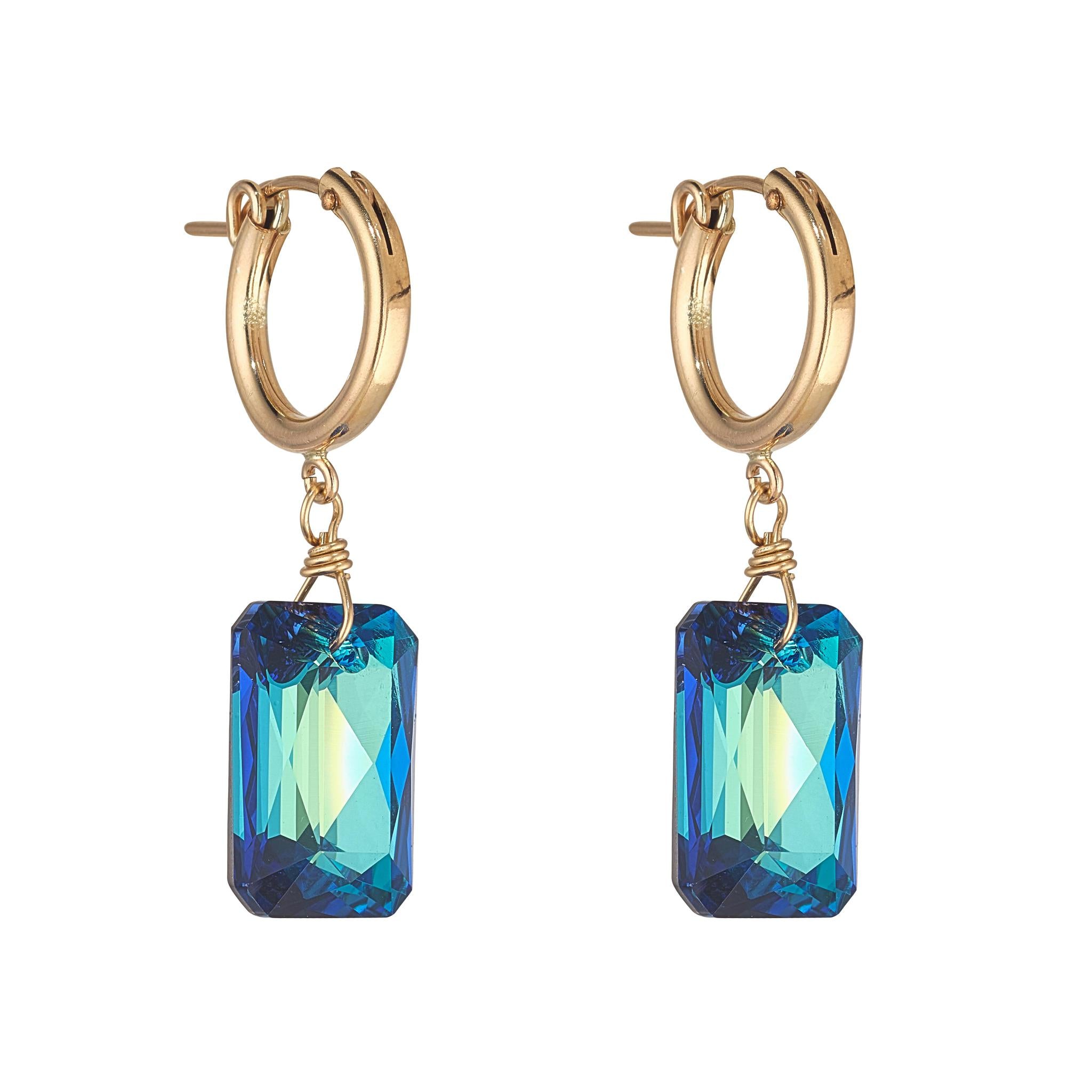 A pair of gold-filled clip hoop earrings with emerald cut Bermuda blue crystals.