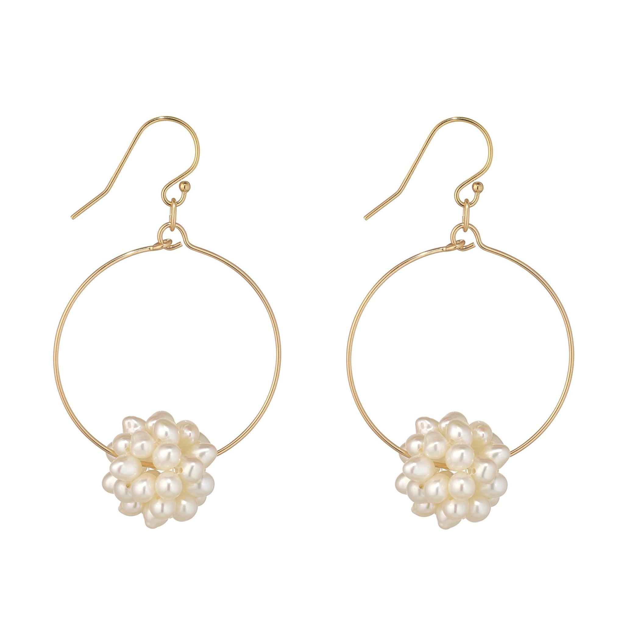 A pair of gold filled hoop earrings with pearl clusters centred on the hoop