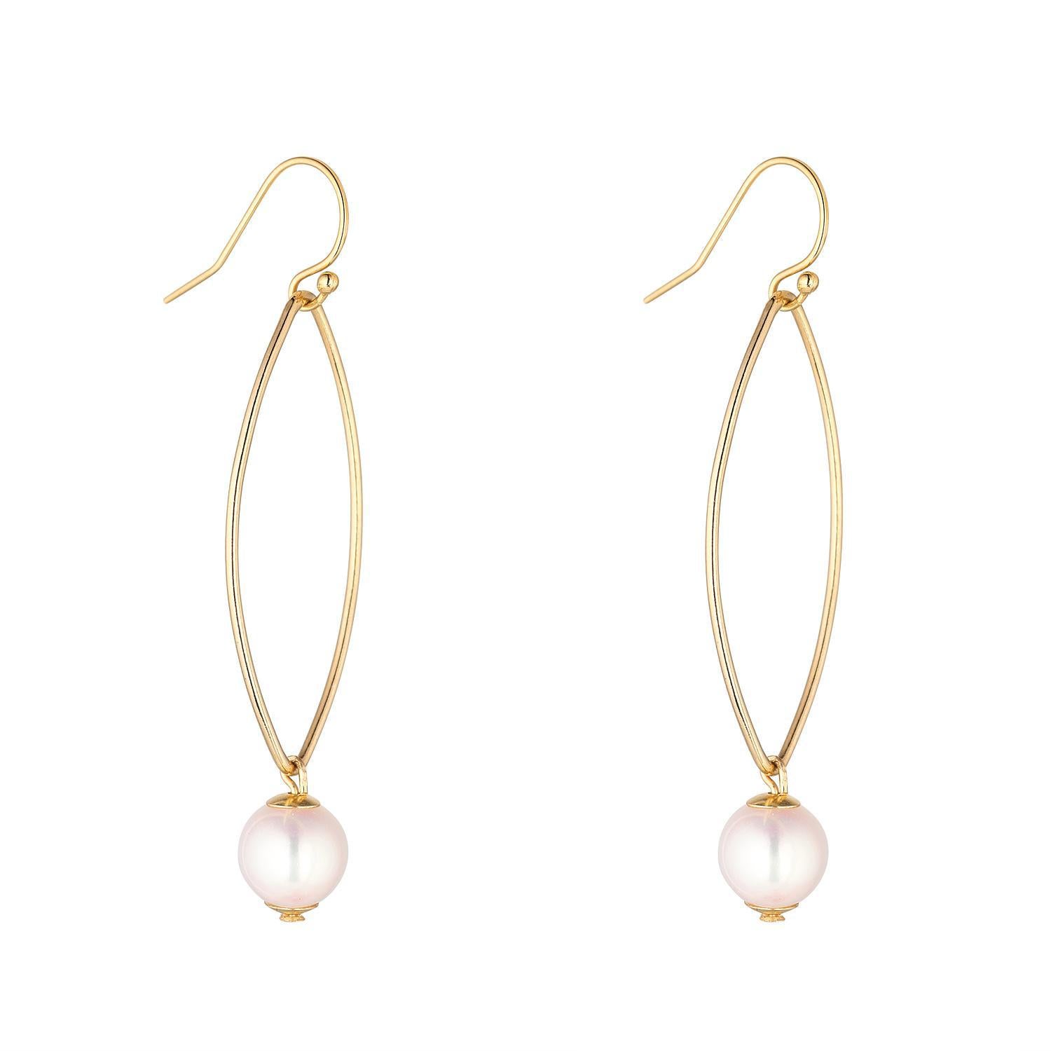A pair of gold-filled oval drop earrings with fresh water pearls.