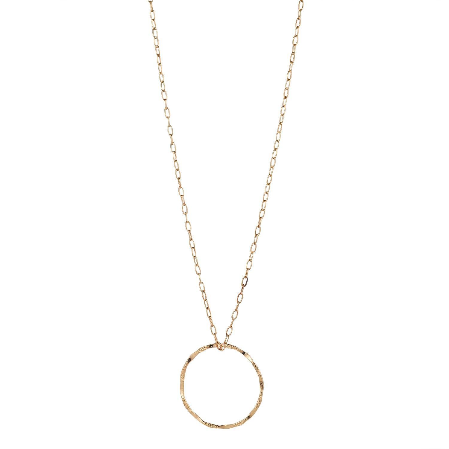 A gold-filled long chain necklace with a large molten circle pendant.