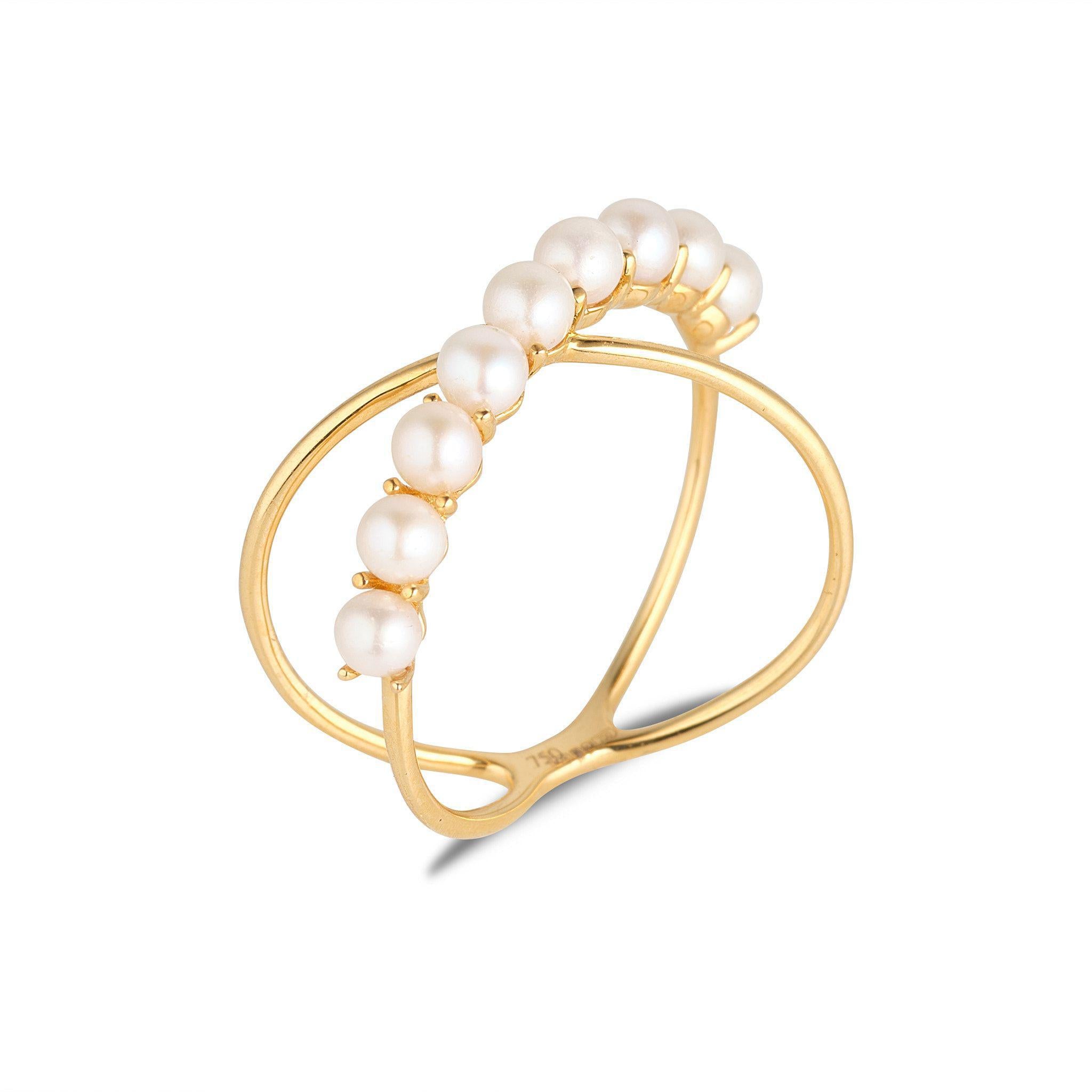 A 18kt yellow gold ring featuring a series of freshwater pearls set in an crossover design.