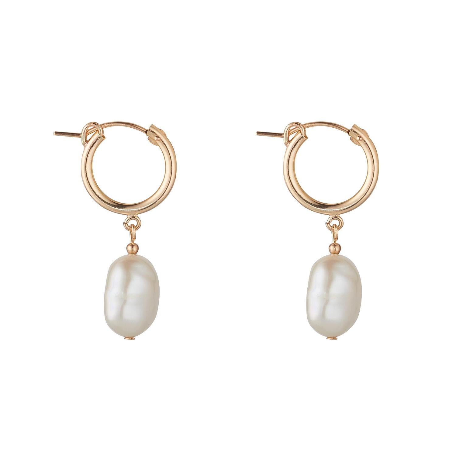 A pair of gold-filled clip hoop earrings with baroque pearls attached.