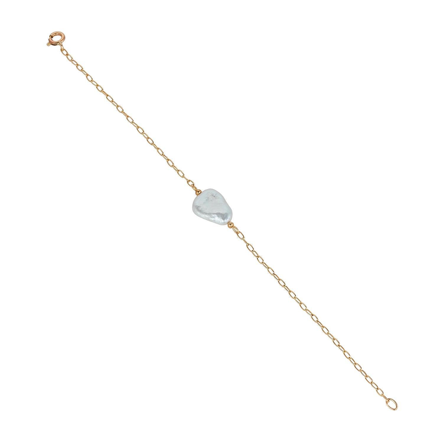 A gold filled bracelet featuring a single baroque pearl on a chain.