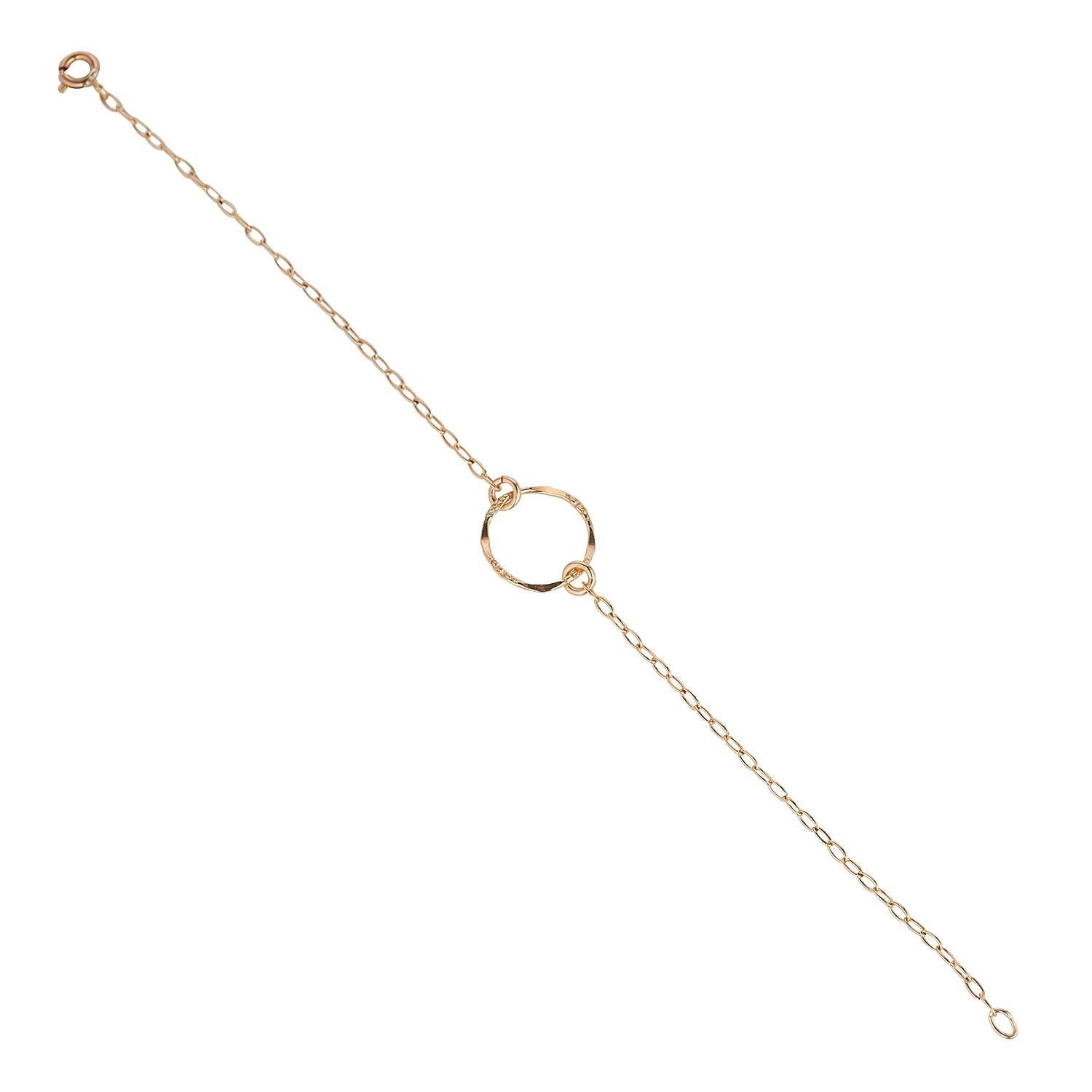 A gold-filled bracelet with a molten circle at the center, available in two different sizes.