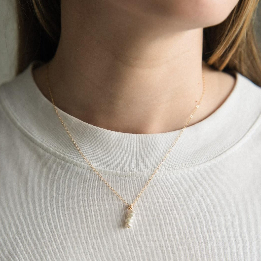 A gold filled pearl mini saucer pendant necklace on a fine gold filled chain