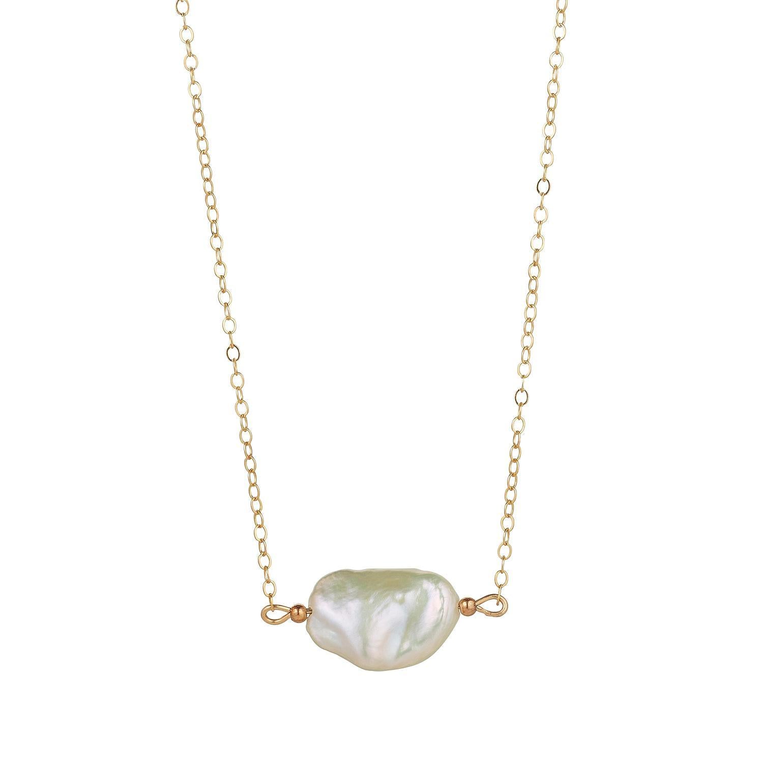 A gold filled chain necklace with a single baroque pearl pendant in the centre.