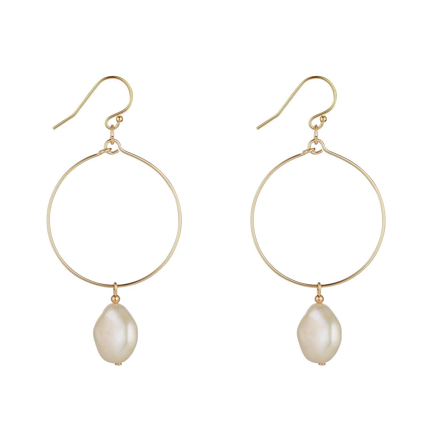 A pair of gold filled hoop earrings with baroque pearls attached.