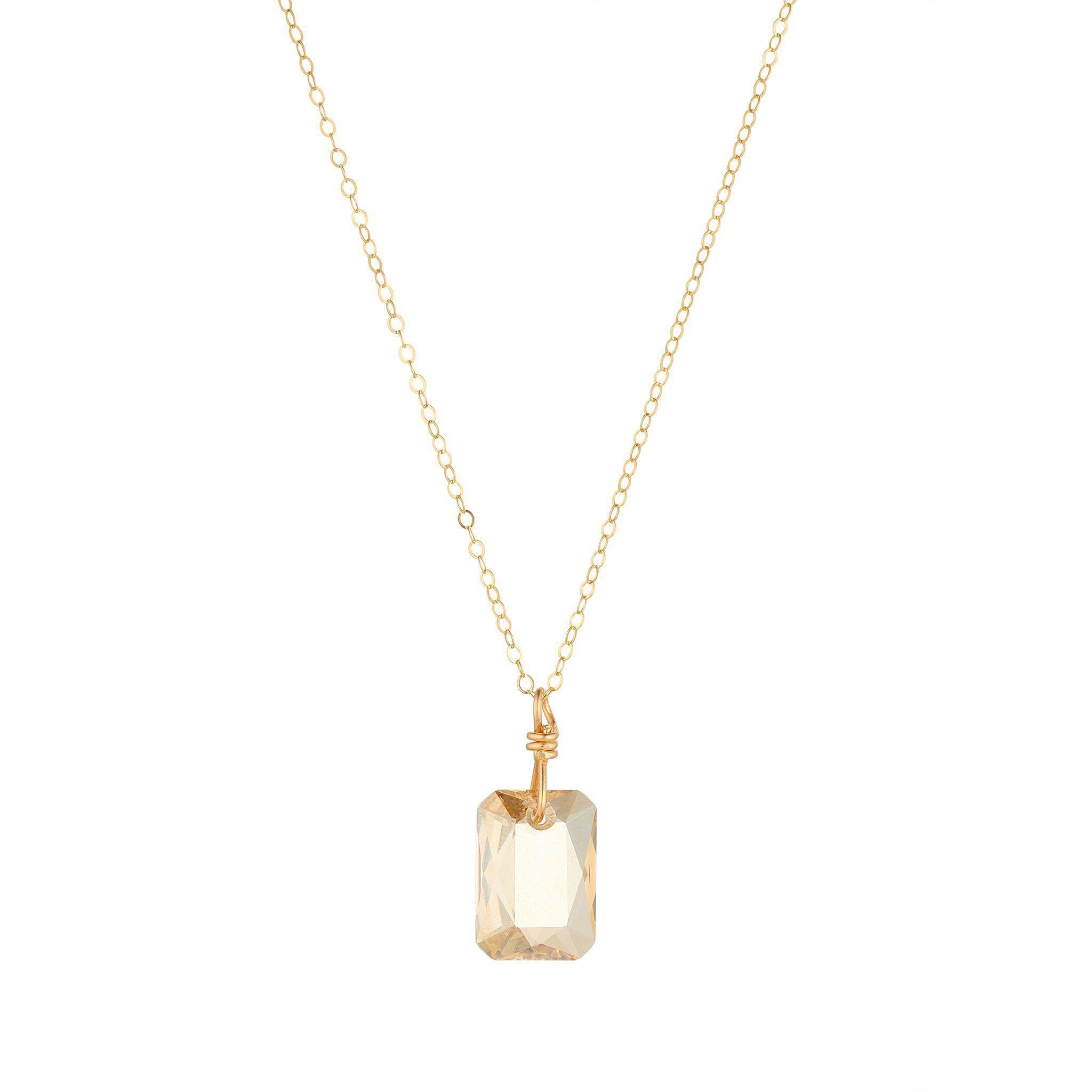A gold filled chain necklace with a 16mm emerald cut golden shadow crystal pendant.